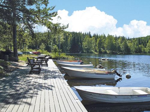 a group of boats parked on a dock on a lake at Holiday Home Ängasjö by Interhome in Östra Frölunda