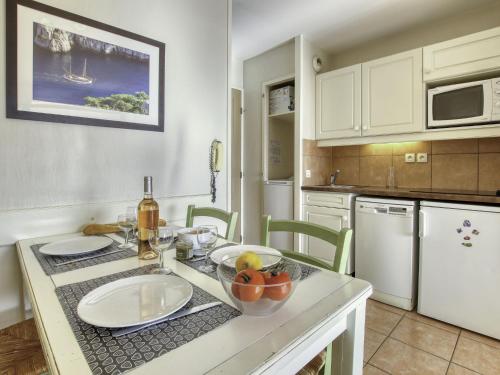 a kitchen with a table with a bowl of fruit on it at Apartment Les Rivages de Coudoulière-8 by Interhome in Six-Fours-les-Plages