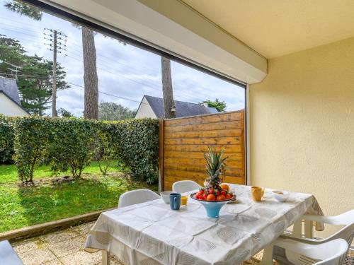 a table with a bowl of fruit sitting on a patio at Studio Le Béniguet by Interhome in Légenès
