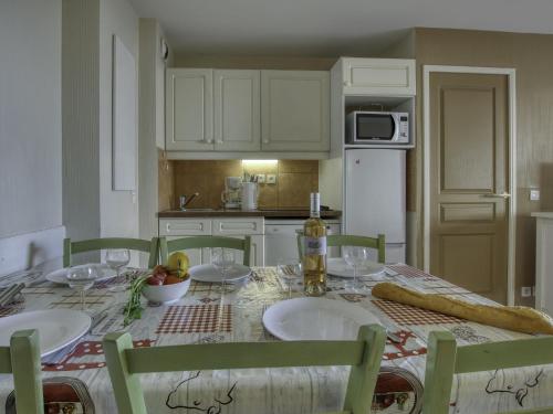 une cuisine équipée d'une table avec deux chaises et d'une table sidx sidx sidx dans l'établissement Apartment Les Rivages de Coudoulière-9 by Interhome, à Six-Fours-les-Plages