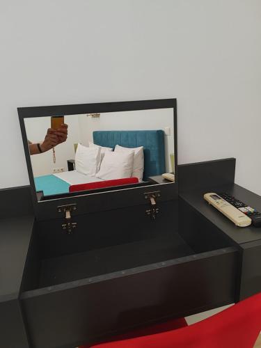 a black dresser with a mirror on top of a bed at Δροσιά in Nafplio