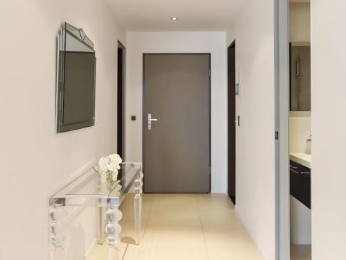 a hallway with a glass table and a door at Apartment Les Terrasses C1-7 by Interhome in Montreux