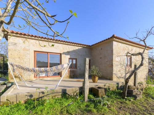 a stone house with a hammock in front of it at Holiday Home Pedra by Interhome in Caminha