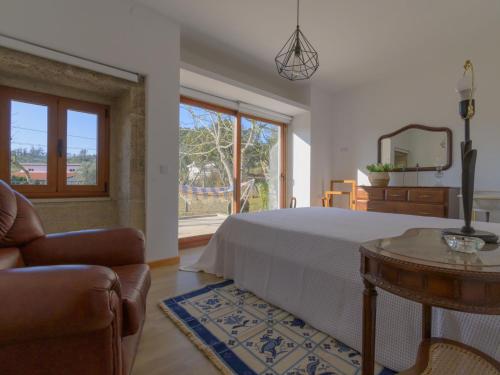 a bedroom with a bed and a table and a mirror at Holiday Home Pedra by Interhome in Caminha