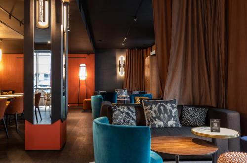 a dining room with blue chairs and tables at Hôtel & Spa Oceania Le Conti in Brest