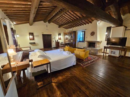 a bedroom with a large bed and a living room at EcoResort Il Cantico della Natura in Magione