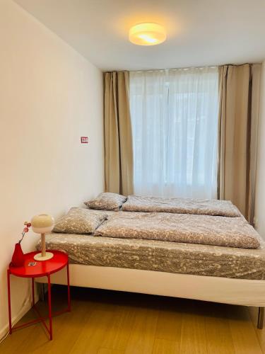 a bedroom with a large bed and a red table at Královské apartmá kolonáda in Poděbrady