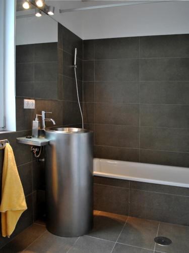 a bathroom with a large metal tub and a sink at Villa Ermita in Puntagorda