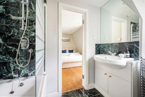 a bathroom with a sink and a shower at The Mayfair Marvel in London