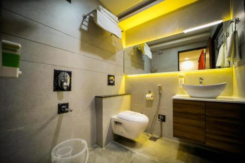 a bathroom with a white toilet and a sink at The RRA Kabras Hotel, Nathdwara in Nāthdwāra