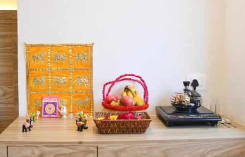 a table with a basket of fruit and a bowl of food at The RRA Kabras Hotel, Nathdwara in Nāthdwāra