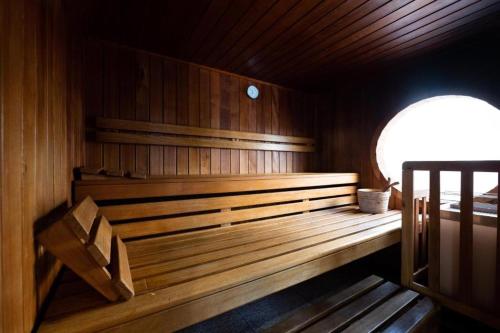 a sauna with a bench in a wooden room at Victoria bilocale centro città e vista mare in Menton
