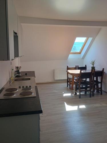 a kitchen and dining room with a stove and a table at Agroturystyka U Puchatka in Rebiszów