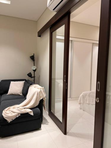 a living room with a mirror and a couch at Amazing Apartment in Salalah