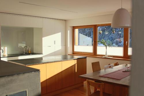 uma cozinha com uma mesa e uma sala de jantar em Sonnennest em Hirschegg