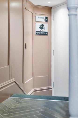 a hallway with a door with a sign on it at Hestia House in Derry Londonderry