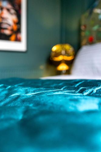 a close up of a blue blanket on a bed at Hestia House in Derry Londonderry