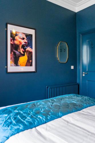 a bedroom with a painting on the wall and a bed at Hestia House in Derry Londonderry
