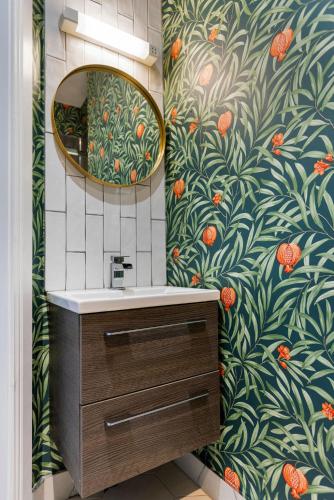 a bathroom with a sink and a mirror at Hestia House in Derry Londonderry