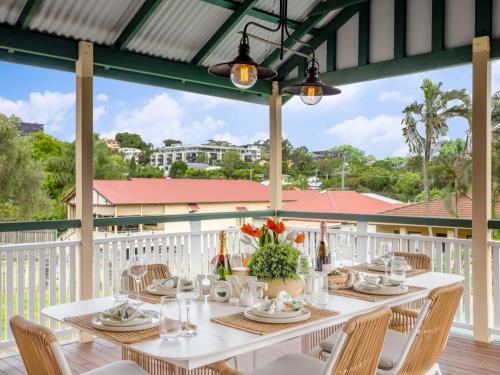 a white table with chairs on a balcony at Charming 3BR Inner City Haven Highgate Hill in Brisbane