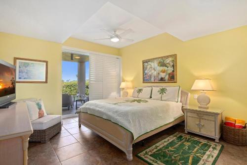 a bedroom with a bed and a living room at Vista Waikoloa A104 in Waikoloa