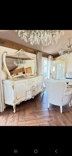 a bedroom with a large white bed and a mirror at Badgers rest lodge in Kinlet