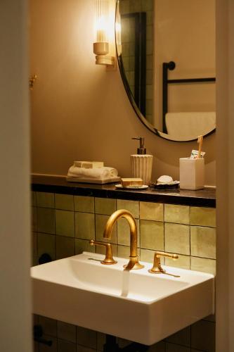 a bathroom with a sink and a mirror at No.124 by GuestHouse, Brighton in Brighton & Hove