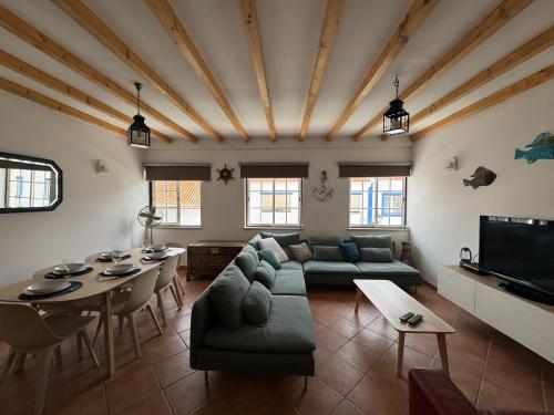 a living room with a couch and a table at Porto Covo / Costa Alentejana in Porto Covo