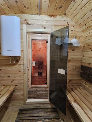 baño en una cabaña de madera con espejo en Экопарк, en Bălţi