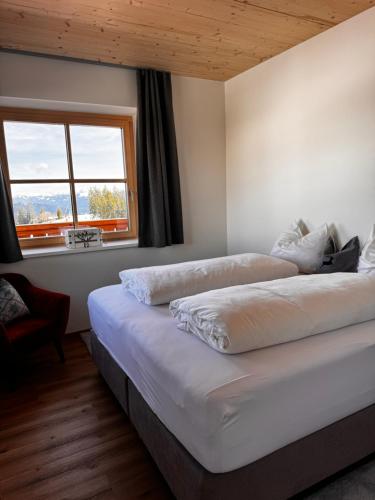 a bedroom with two beds and a window at GLOCKNERALM in Zell am See