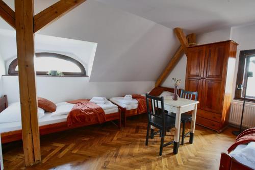 a bedroom with two bunk beds and a table at Penzion Pivovar Volt in Jablonec nad Nisou