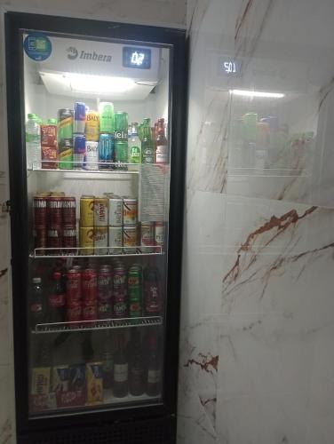 a refrigerator filled with lots of drinks at Hotel Endless Love in Carapicuíba