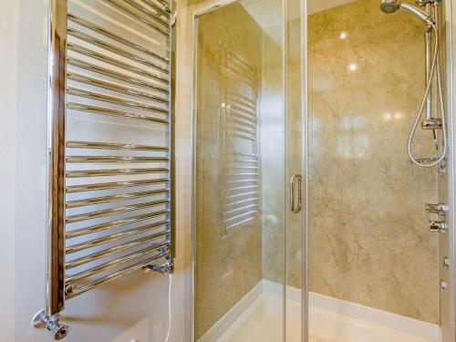 a shower with a glass door in a bathroom at 2 Bed in South Molton ISLVI in South Molton
