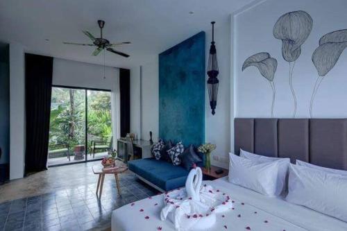 a bedroom with a bed and a living room at Theary Luxury Villa in Siem Reap