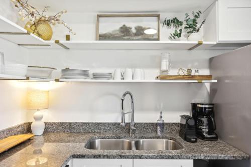 a kitchen with a sink and a counter top at Crystal City Boutique Flats 2BR - Free Parking 204 in Arlington