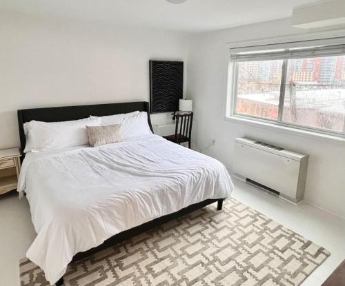 a bedroom with a large bed and a window at Crystal City Boutique Flats Free Parking 201 in Arlington