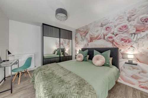 a bedroom with a bed with roses on the wall at 44m² - Cosy - Neuf - Parking in Massy