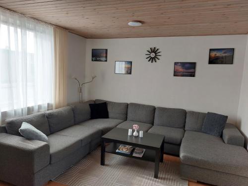 a living room with a couch and a table at Venos rooms in Hirtshals