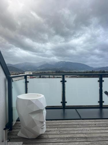 a white toilet sitting on top of a wooden deck at Murtal Appartement Größingblick Top 5 in Zeltweg