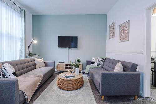 a living room with two couches and a tv at Stylish House in Manchester Sleeps7 Wifi & Parking by PureStay in Manchester
