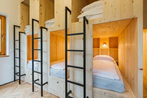 a row of bunk beds in a tiny house at 2nd Station Hostel in Bled