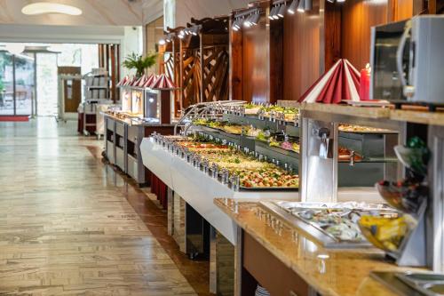 a buffet line with many different types of food at Aquapark Health Resort & Medical SPA Panorama Morska All Inclusive in Jarosławiec