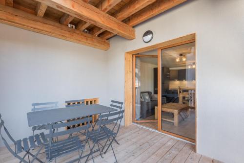- une salle à manger avec une table et des chaises sur du parquet dans l'établissement La Maya - Appt vue montagne, à Vars