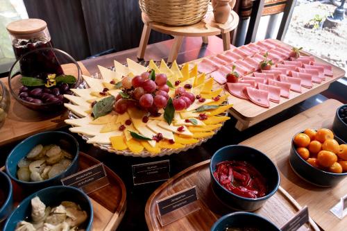 a table topped with different types of food on plates at Union Hotel Cusco in Cusco
