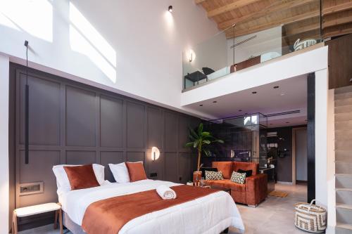 a bedroom with a large bed and a loft at MY Luxury Suites - Old Town Rethymno in Rethymno Town