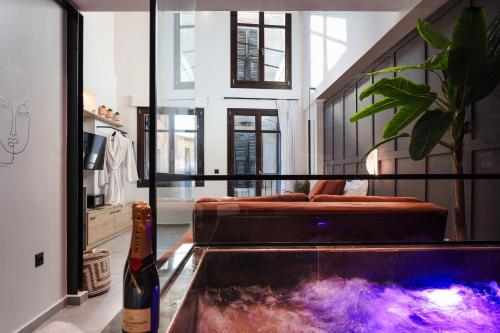 a large aquarium in a room with a bottle of wine at MY Luxury Suites - Old Town Rethymno in Rethymno Town