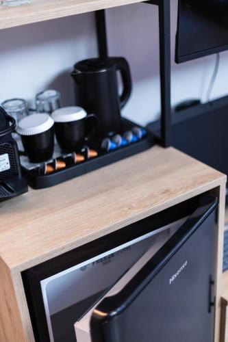 a kitchen counter with a shelf with pots and pans at My Luxury Downtown Vibe Suites in Rethymno