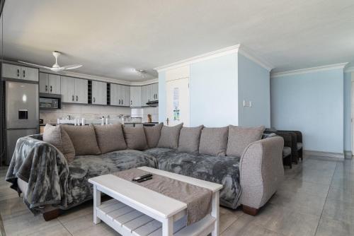 a living room with a couch and a table at Chakas Cove 38 in Ballito