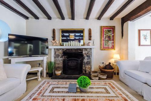 a living room with a fireplace and a tv at Spacious 5BR Home w/Game Room in Ruthin
