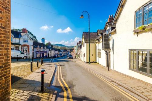 an empty street in a town with buildings at Spacious 5BR Home w/Game Room in Ruthin